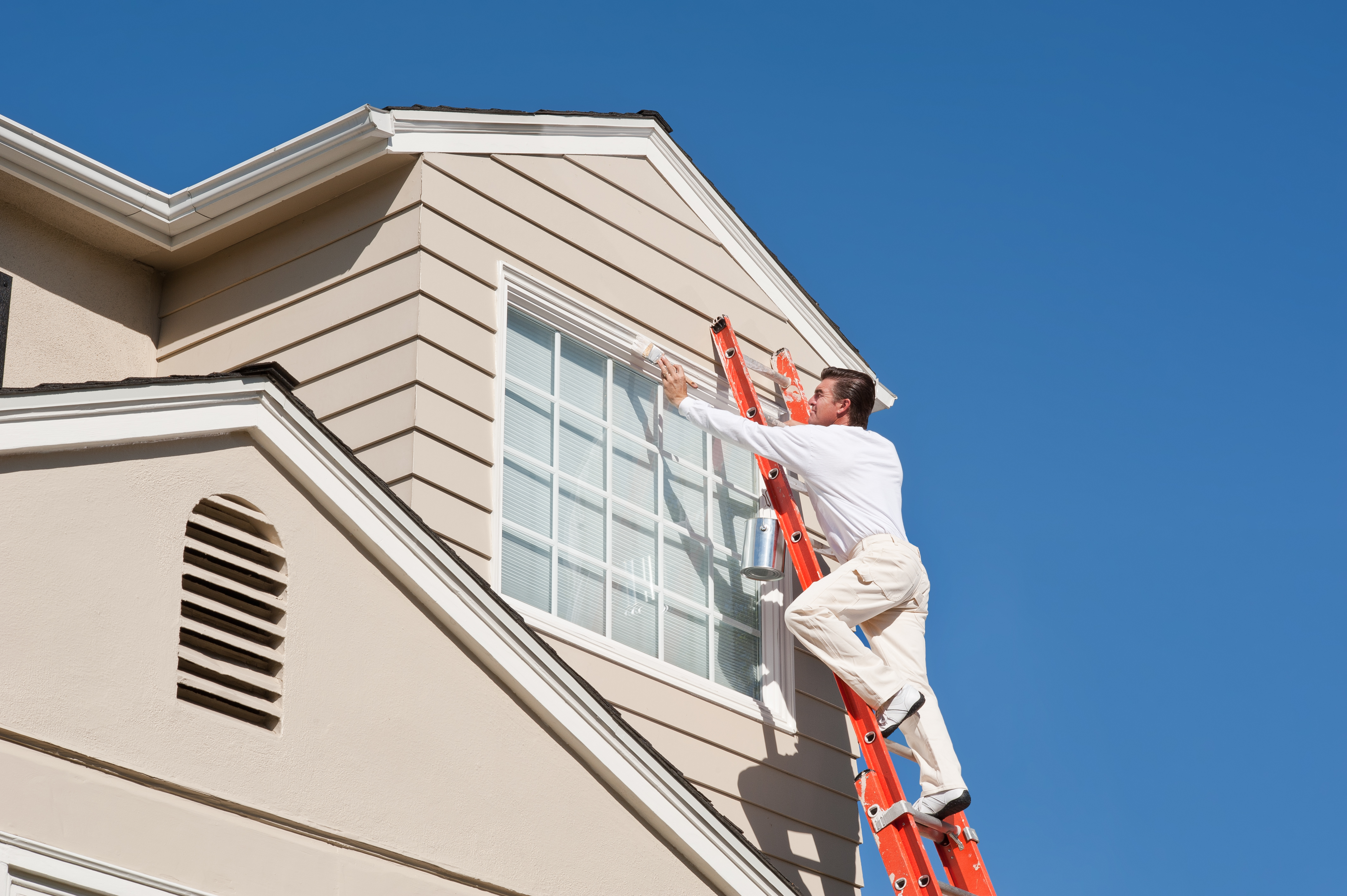 Front Range Painting crew working on a Fort Collins home exterior.